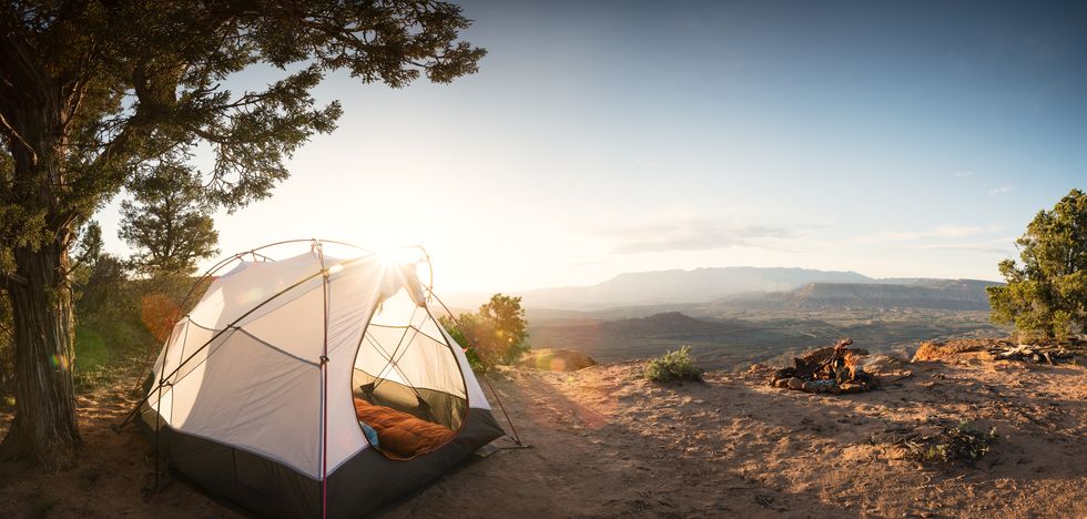 tent-camping-under-a-pinon-tree-in-the-desert-first-royalty-free-image-1645542991.jpg